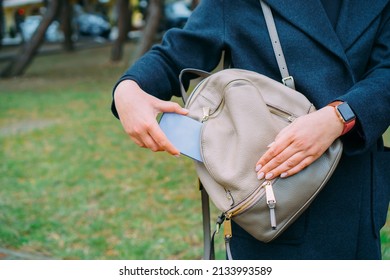 The Woman Puts The Phone In The Pocket Of Her Bag.