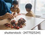 A woman puts potpourri into a mesh bag, and brothers playing in the background. The concept of a room freshener that is safe for use by families