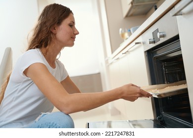 Woman Puts Prepared Dish On A Baking Sheet With Parchment