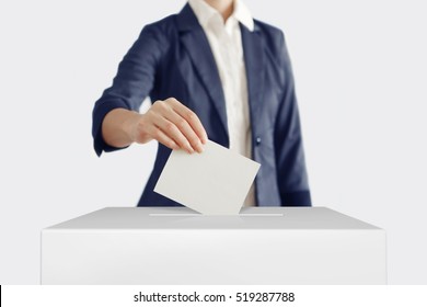 Woman Putting A Ballot Into A Voting Box.