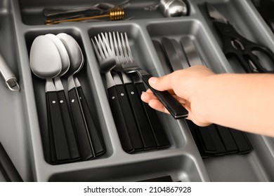 Woman Putting Clean Fork Into Kitchen Drawer, Closeup