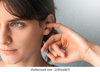 Woman Putting A Finger Into Her Ear  Itchy Ear Isolated With Copy Space.