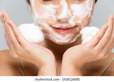 Woman putting foam on face. - Powered by Shutterstock