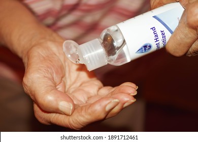 Woman Putting Hand Sanitizer On Hands Closeup