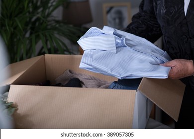 Woman Putting Her Dead Husband Clothes Into A Box