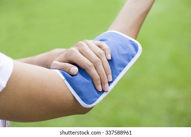 Woman Putting An Ice Pack On Her Arm Pain