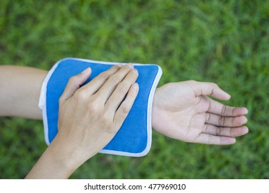 Woman Putting An Ice Pack On Her Arm Pain