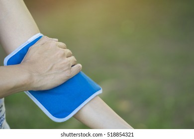 Woman Putting An Ice Pack On Her Arm Pain