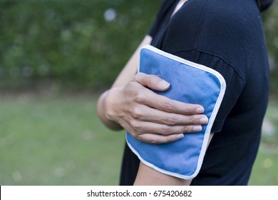 Woman Putting An Ice Pack On Her Arm Pain