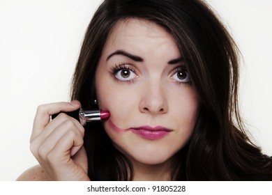 woman putting make up on and it when a bit to far so she looks silly