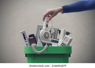 Woman Putting An Old Broken Appliance In The Trash Bin, E-waste And Recycling Concept