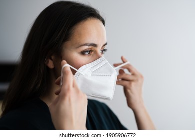 Woman Putting On Medical N95 Face Mask
