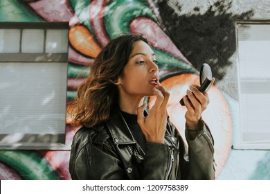 Woman Putting On Red Lipstick