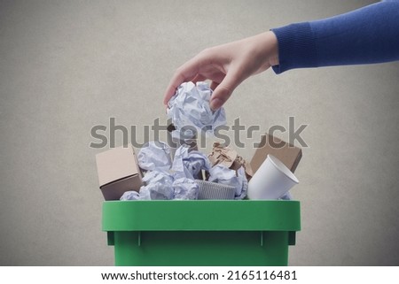 Woman putting paper in the waste bin, separate waste collection and recycling concept Foto stock © 