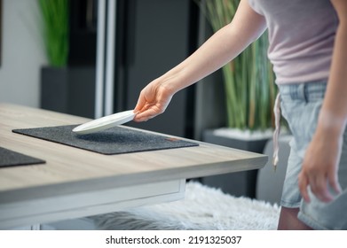 Woman Putting Plate On A Table To Eat