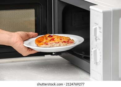 Woman Putting Plate Pizza Into Microwave Stock Photo (Edit Now) 2124769277