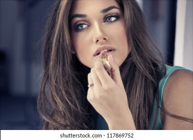 Woman Putting Red Lipstick Looking In Mirror.