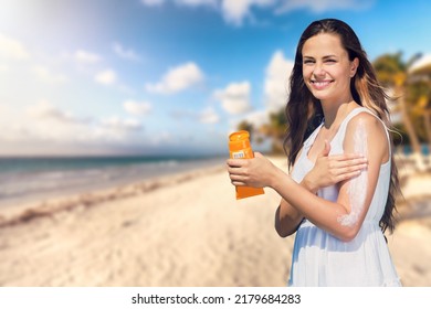 Woman Putting Sunblock Lotion Before Tanning During Summer Holiday On Beach. Sun Cream. Skin Care. Sun Protection