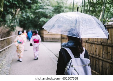 Woman putting up an umbrella in Kyoto