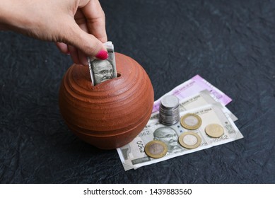 Woman Putting Wages In Coin Stack Jar Saving Money For Her Child. Kids Piggy Bank For Savings Cash Deposit For Future. 500 Rupee Banknote India. Profit From Business. New Indian Currency Notes Of 2000