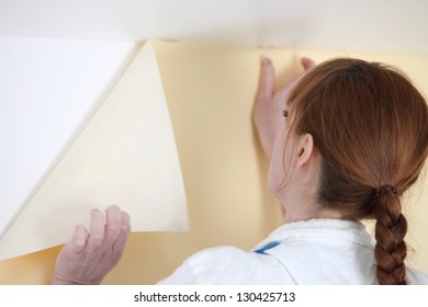 Woman Putting Up Wallpaper