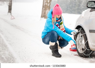 Woman Putting Winter Tire Chains On Car Wheel Snow Breakdown