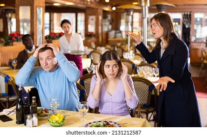 Woman Quarreling With Her Husband Who Dating In Restaurant With Young Mistress.