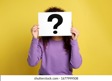 Woman With Question Mark Sign On Yellow Background