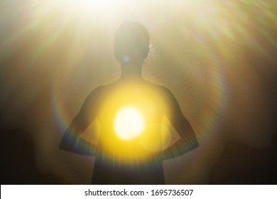 Woman radiating light from within into an opening of spiritual heart.