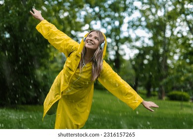 Woman in raincoat enjoying the rain - Powered by Shutterstock