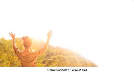 Woman raised hands up on top of mountain and sunset banner background.Freedom, Pray, Holy spirit, Good friday, Easter, Prayer, Praise the LORD.Blessed to the nation.Christian background.peace, mind.