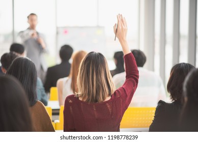 Woman Raising Up Hand For Asking The Speaker And The Speaker Point The Woman In Seminar Meeting Room Back Side