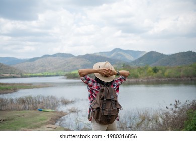 Woman Raising Hands Up On The Banks Of The Lake. Asian Woman Hiker In Front Smiling Happy, Woman Hiking In Woods, Warm Summer Day.