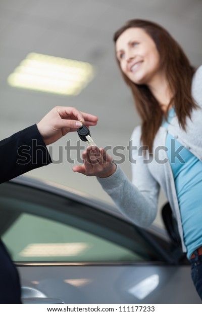 Woman reach out\
hand to get keys in a\
garage