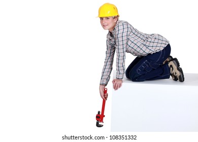 Woman Reaching Down With A Wrench