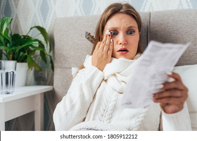 Woman Read Medicine Leaflet Before Taking Pills Lying In Bed. Careful Female Checking Medication Instructions For Safe Use With Surprised Face.