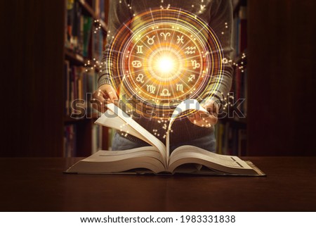 Woman reading a astrology book. Astrological wheel projection, choose a zodiac sign. Trust horoscope future predictions, consulting stars. Power of universe, astrology esoteric concept.