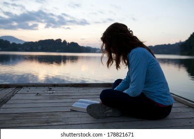 Woman Reading Bible At Sunrise