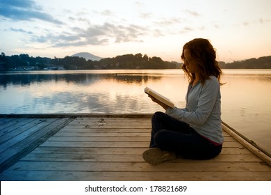 Woman Reading Bible At Sunrise