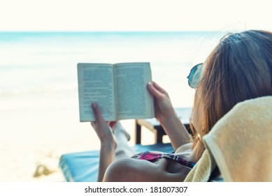 Woman Reading A Book At The Beach