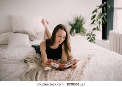 Woman Reading A Book In Bed