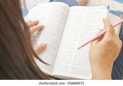 woman reading a book dictionary english for study - Shutterstock ID 556848571