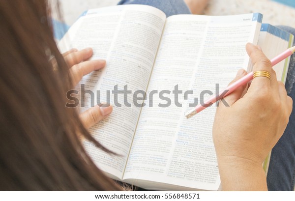 woman reading\
a book dictionary english for\
study