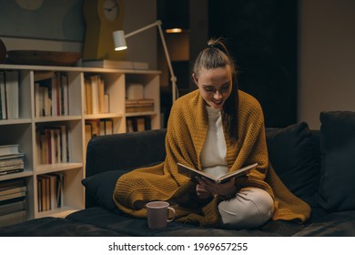 woman reading book at home - Shutterstock ID 1969657255