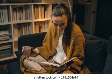 woman reading book at home. - Shutterstock ID 1981504694