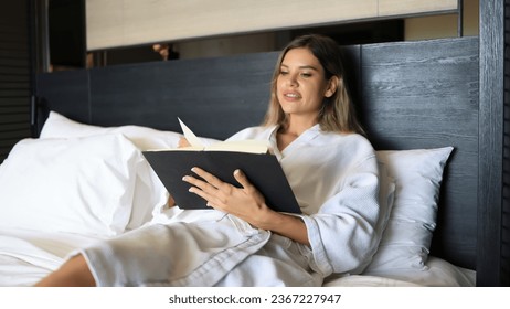 A woman reading book lying on bed at bedroom , Chill out Living lifestyle - Shutterstock ID 2367227947