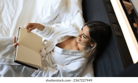 A woman reading book lying on bed at bedroom , Chill out Living lifestyle - Shutterstock ID 2367227949
