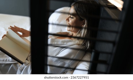A woman reading book lying on bed at bedroom , Chill out Living lifestyle - Shutterstock ID 2367227951