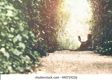 Woman Reading Book In A Magic Garden