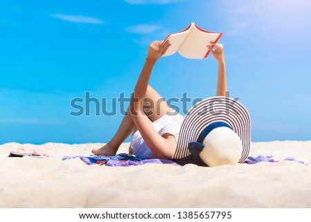 Woman reading a book on the tropical beach with relax on vacation time. Freedom travel concept.